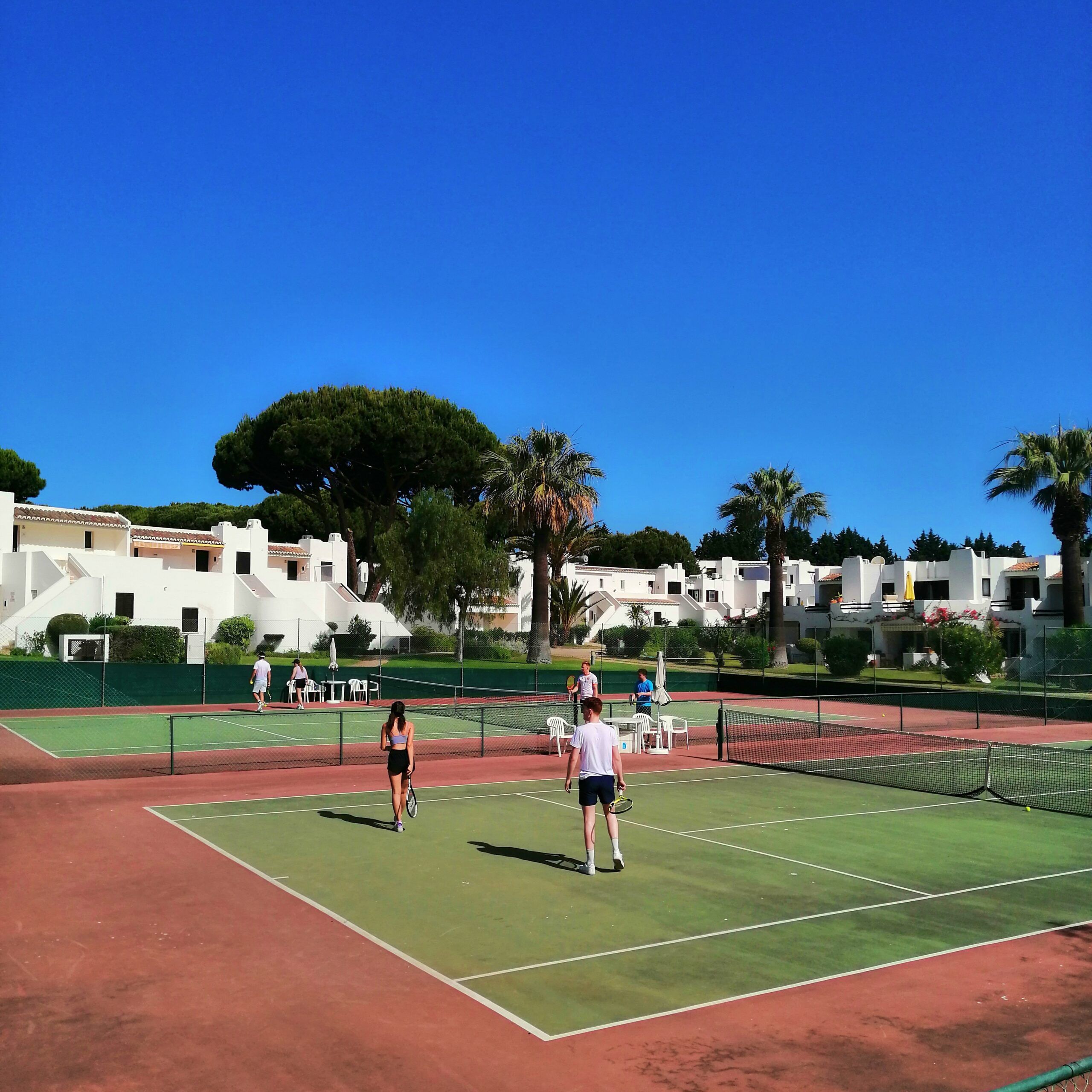 Professional tennis coaching on court at Albufeira Clube de Ténis